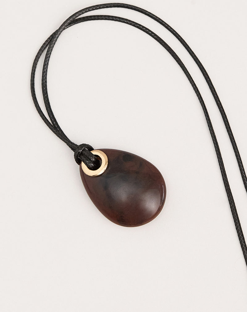 Photo d'un collier à cordon noir avec un pendentif ovale